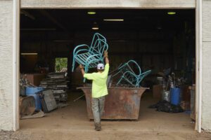 a metal chair being recycled by the Silver Star Salvage and Recycling crew